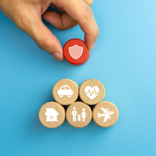 Insurance concept. Wooden blocks with insurance icons. family, life, car, travel, health and house insurance icons. blue background with copy space